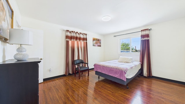 912 W 7th St, Pecos, TX 79772 - bedroom with wood finished floors and baseboards