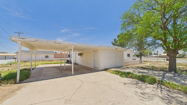 912 W 7th St, Pecos, TX 79772 - view of front facade with concrete driveway and concrete block siding