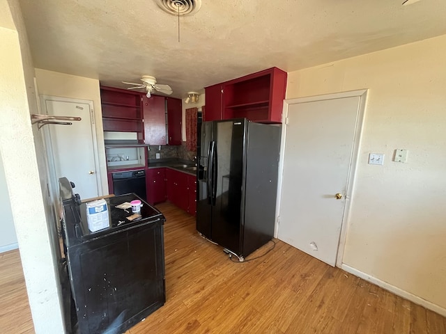 3501 Merrill Ave, Odessa, TX 79764 - kitchen featuring open shelves, black appliances, red cabinetry, light wood finished floors, and a ceiling fan