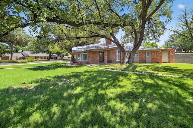2720 Fair Oaks Cir, Odessa, TX 79762 - view of front of house with a front lawn, brick siding, and a chimney