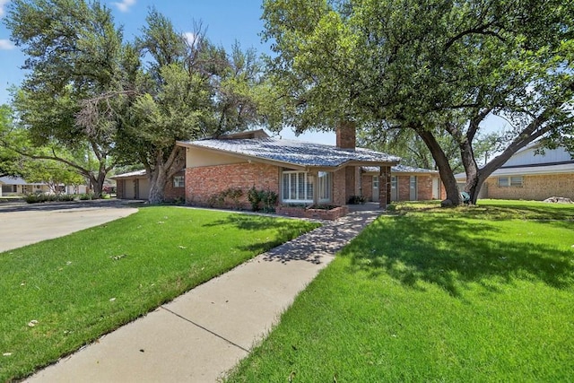 2720 Fair Oaks Cir, Odessa, TX 79762 - view of front facade featuring brick siding, a front lawn, and a chimney