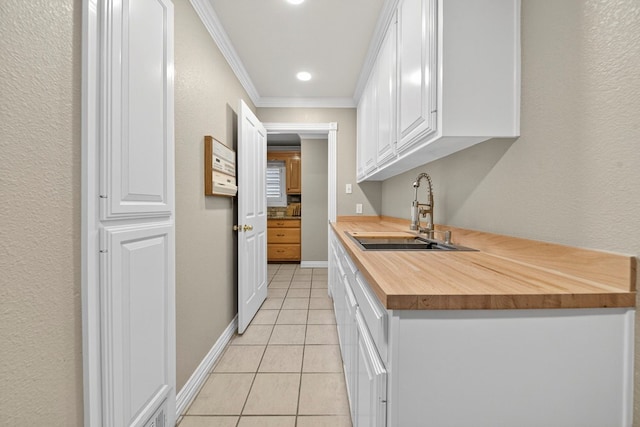2720 Fair Oaks Cir, Odessa, TX 79762 - kitchen featuring wood counters, ornamental molding, white cabinetry, and light tile patterned floors