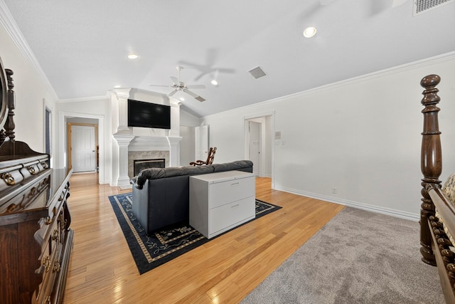 2720 Fair Oaks Cir, Odessa, TX 79762 - living area featuring a ceiling fan, light wood-style floors, vaulted ceiling, a glass covered fireplace, and ornamental molding
