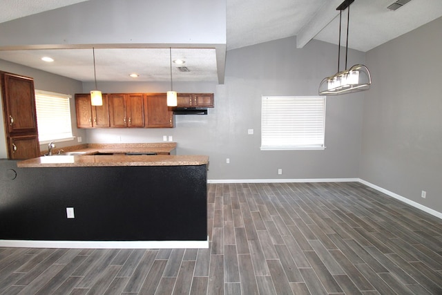 1721 E 56th St, Odessa, TX 79762 - kitchen featuring dark wood-style floors, baseboards, under cabinet range hood, brown cabinetry, and recessed lighting