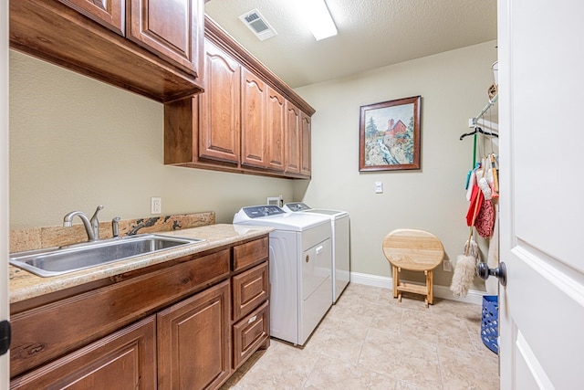 1006 W Cuthbert Ave, Midland, TX 79701 - laundry area featuring cabinet space, independent washer and dryer, and light tile patterned flooring