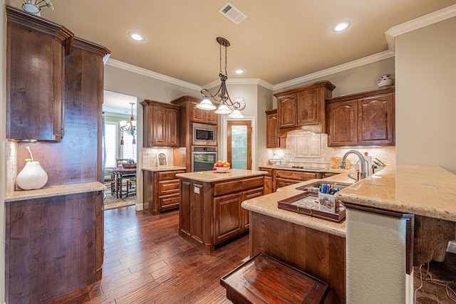1006 W Cuthbert Ave, Midland, TX 79701 - kitchen featuring appliances with stainless steel finishes, a chandelier, tasteful backsplash, a center island, and recessed lighting