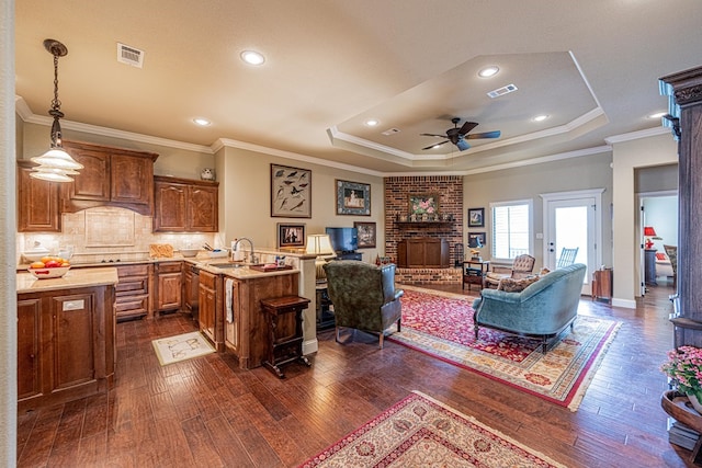 1006 W Cuthbert Ave, Midland, TX 79701 - living room featuring a raised ceiling, dark wood-style floors, ceiling fan, crown molding, and recessed lighting