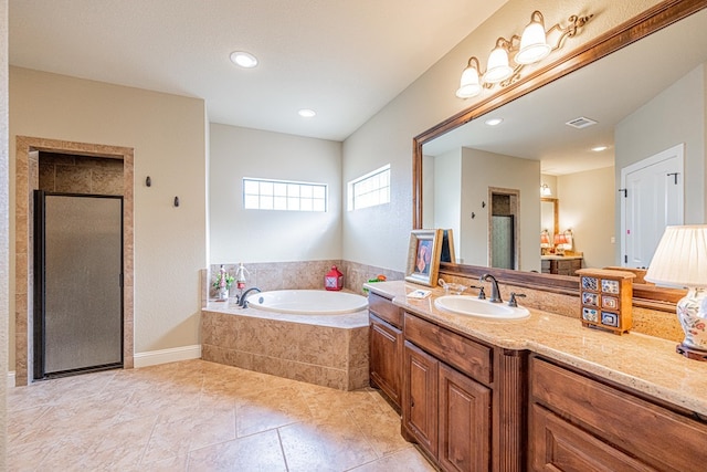 1006 W Cuthbert Ave, Midland, TX 79701 - full bath featuring a garden tub, vanity, tile patterned flooring, a shower stall, and recessed lighting