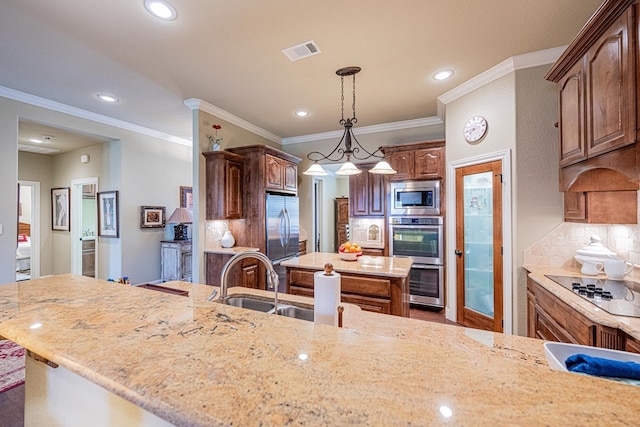 1006 W Cuthbert Ave, Midland, TX 79701 - kitchen featuring appliances with stainless steel finishes, a kitchen island, recessed lighting, light stone counters, and crown molding