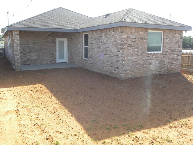 309 S Hancock Ave, Odessa, TX 79761 - back of house with brick siding and roof with shingles