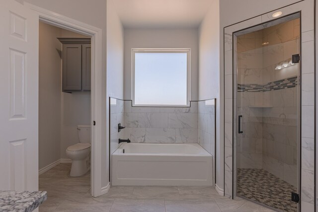 309 S Hancock Ave, Odessa, TX 79761 - bathroom with a garden tub, a stall shower, and marble look tiles