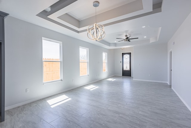309 S Hancock Ave, Odessa, TX 79761 - unfurnished room featuring a raised ceiling, a chandelier, and a ceiling fan