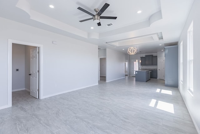 309 S Hancock Ave, Odessa, TX 79761 - unfurnished living room with a raised ceiling, ceiling fan, and recessed lighting