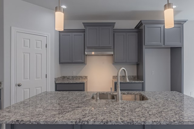 309 S Hancock Ave, Odessa, TX 79761 - kitchen with light stone counters, range hood, hanging light fixtures, recessed lighting, and gray cabinetry