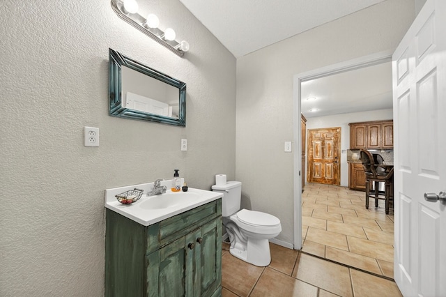 1321 Lindberg St, Odessa, TX 79763 - bathroom featuring vanity, a textured wall, and tile patterned flooring