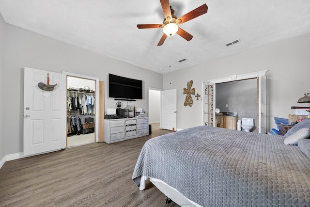 1321 Lindberg St, Odessa, TX 79763 - bedroom featuring wood finished floors, a walk in closet, connected bathroom, a closet, and ceiling fan