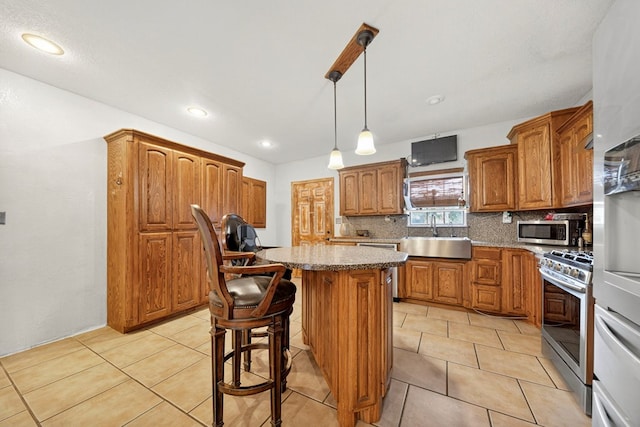 1321 Lindberg St, Odessa, TX 79763 - kitchen featuring appliances with stainless steel finishes, decorative backsplash, a center island, brown cabinetry, and recessed lighting