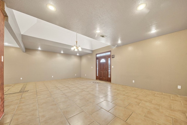 1321 Lindberg St, Odessa, TX 79763 - spare room featuring a textured ceiling, recessed lighting, tile patterned floors, and a chandelier