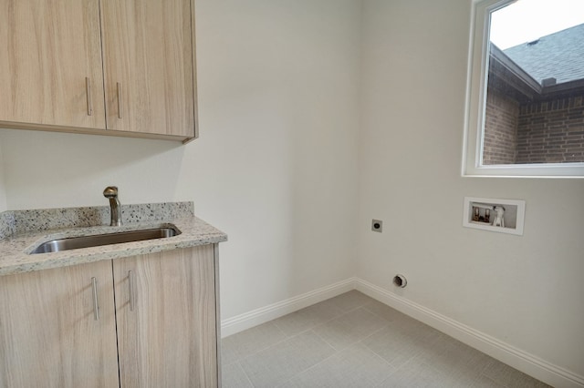 laundry area featuring electric dryer hookup, cabinet space, a sink, baseboards, and hookup for a washing machine