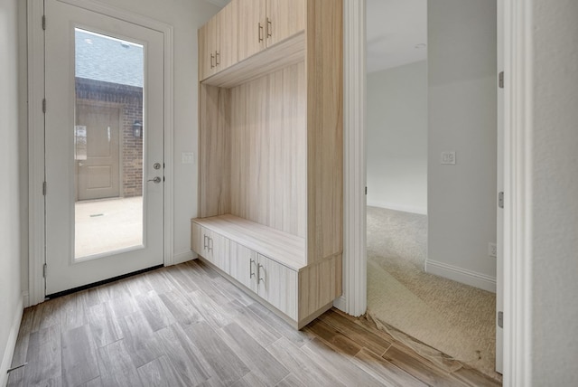 mudroom with baseboards and light wood-style flooring