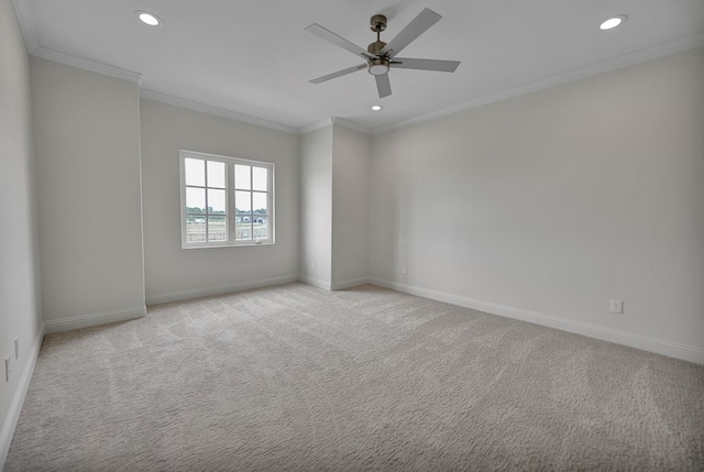 empty room featuring recessed lighting, crown molding, and light colored carpet