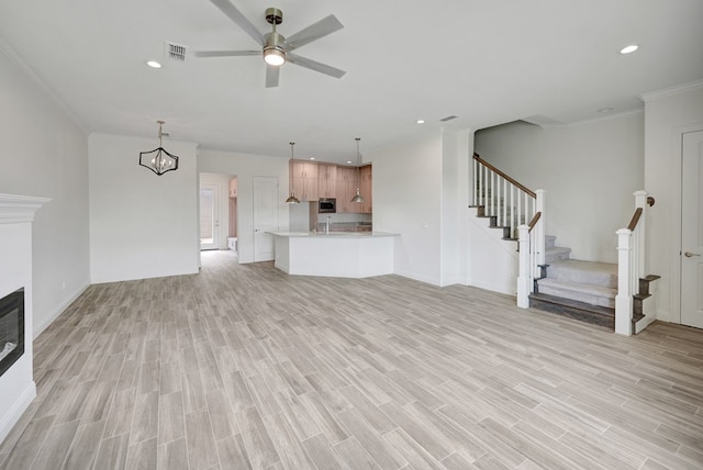 unfurnished living room featuring visible vents, recessed lighting, stairs, and light wood-type flooring