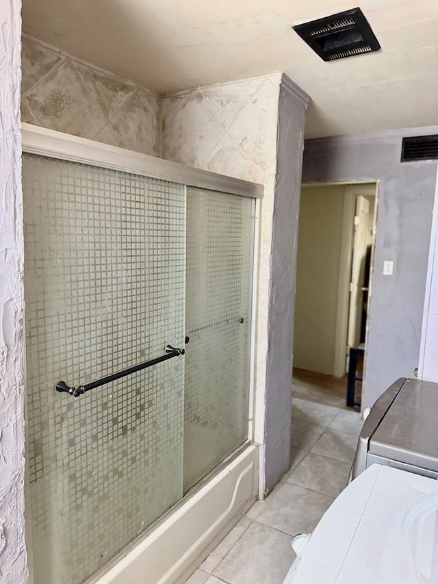 189 County Road 401-l, Seminole, TX 79360 - full bathroom with combined bath / shower with glass door and washer and dryer
