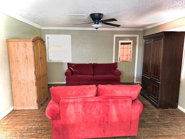 189 County Road 401-l, Seminole, TX 79360 - living area featuring dark wood-style flooring, a ceiling fan, a textured ceiling, and crown molding