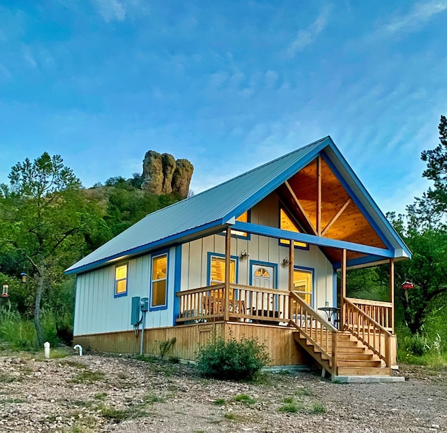 307 Cochise Canyon Trl, Fort Davis, TX 79734 - rear view of house with covered porch, board and batten siding, and metal roof