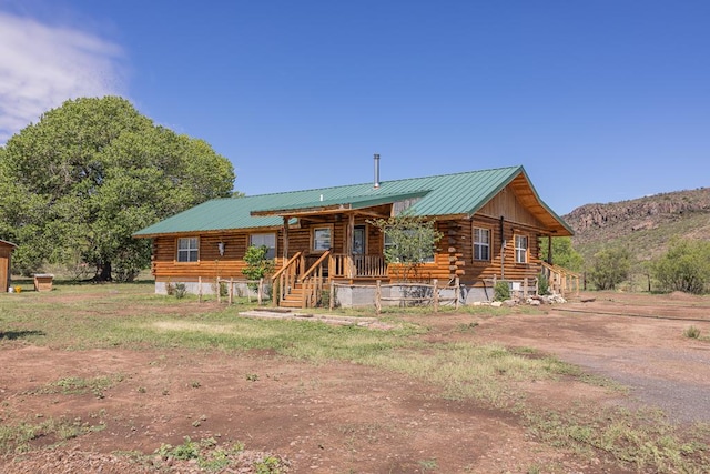 43169 State Highway 17, Fort Davis, TX 79734 - log home with log exterior, a porch, a metal roof, and a mountain view