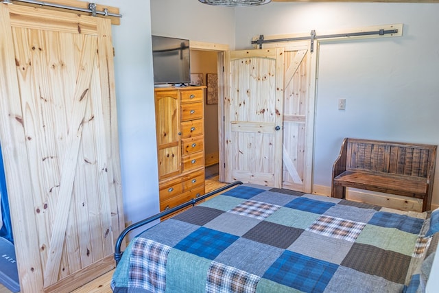43169 State Highway 17, Fort Davis, TX 79734 - bedroom featuring a barn door and wood finished floors
