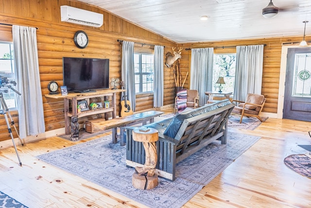 43169 State Highway 17, Fort Davis, TX 79734 - living area with log walls, an AC wall unit, plenty of natural light, hardwood / wood-style flooring, and wooden ceiling