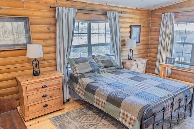 43169 State Highway 17, Fort Davis, TX 79734 - bedroom featuring log walls and light wood-style flooring