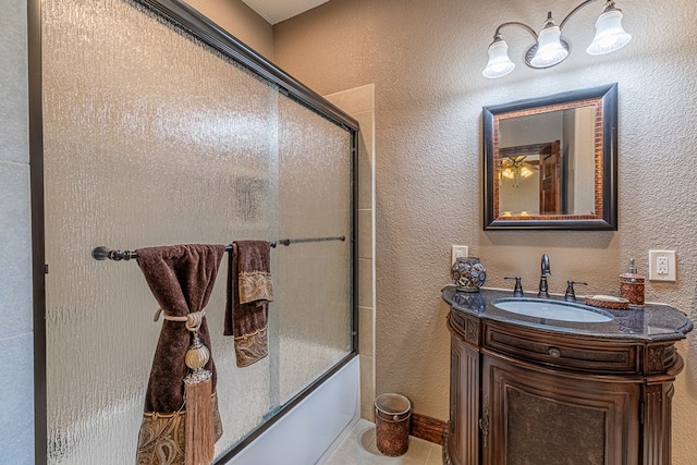 651 Fm 1757, Seminole, TX 79360 - bathroom featuring vanity, combined bath / shower with glass door, and a textured wall
