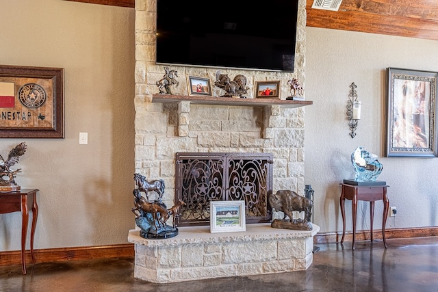 651 Fm 1757, Seminole, TX 79360 - living area featuring finished concrete flooring, a stone fireplace, and a textured wall