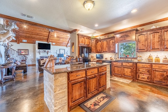651 Fm 1757, Seminole, TX 79360 - kitchen with black appliances, finished concrete floors, dark stone countertops, backsplash, and crown molding
