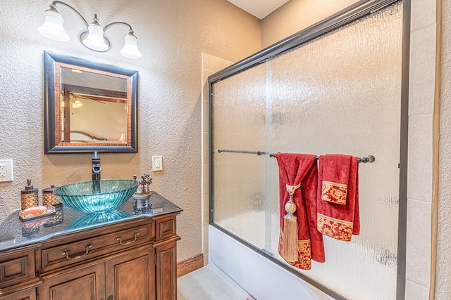 651 Fm 1757, Seminole, TX 79360 - bathroom with vanity, bath / shower combo with glass door, and a textured wall