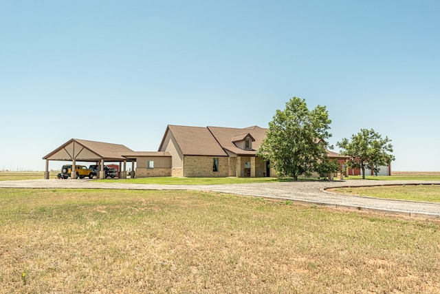 651 Fm 1757, Seminole, TX 79360 - view of front of home featuring a carport, gravel driveway, and a front lawn