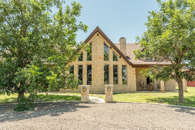 651 Fm 1757, Seminole, TX 79360 - view of front of property with stone siding, a chimney, a patio, and a front lawn