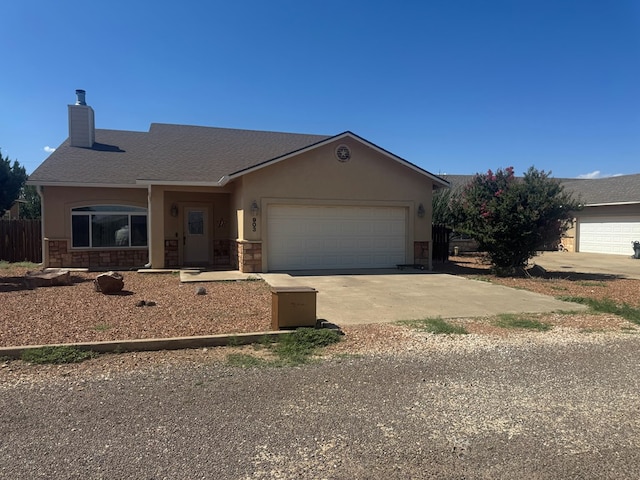 903 W Uvalde Ave, Alpine, TX 79830 - ranch-style house with stone siding, a chimney, concrete driveway, and a garage