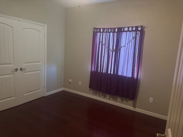 903 W Uvalde Ave, Alpine, TX 79830 - empty room featuring dark wood-style flooring and baseboards