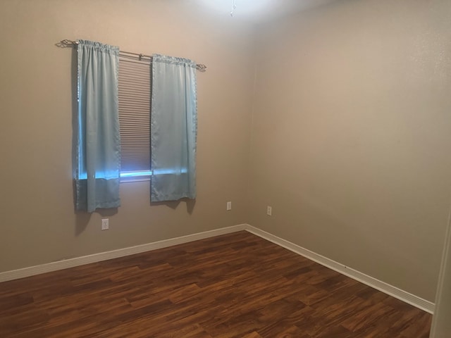903 W Uvalde Ave, Alpine, TX 79830 - empty room featuring dark wood-style flooring and baseboards