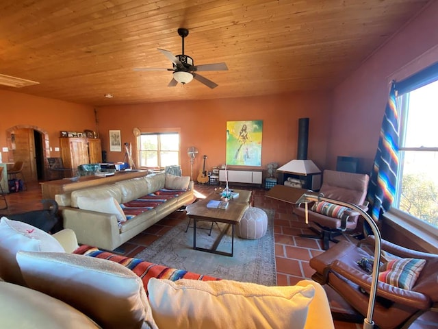 living room with a healthy amount of sunlight, wooden ceiling, and ceiling fan