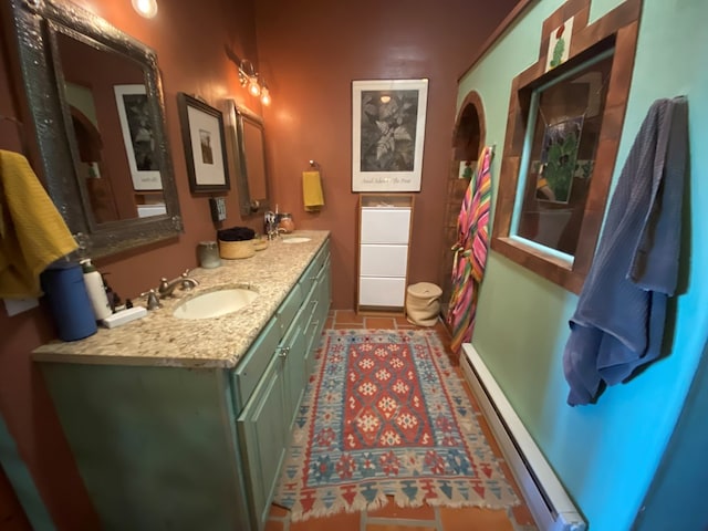 bathroom with baseboard heating, vanity, and tile patterned flooring