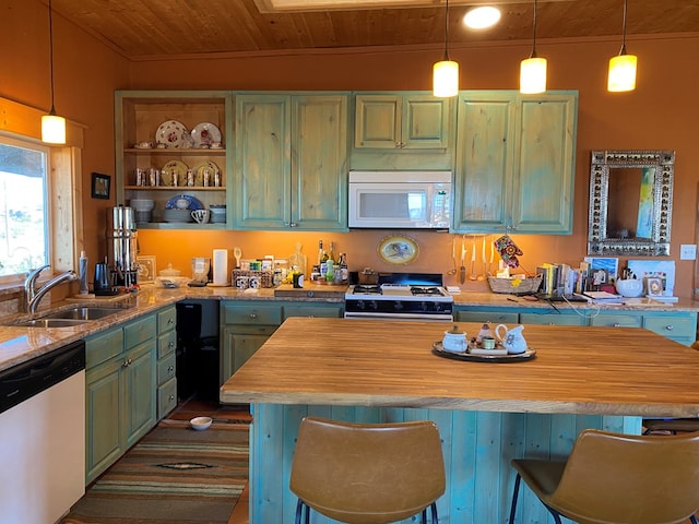 kitchen featuring gas stove, sink, wood ceiling, stainless steel dishwasher, and a kitchen breakfast bar