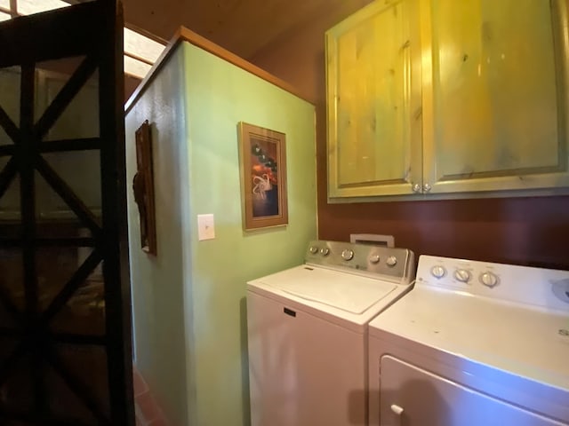 laundry area featuring cabinets and washing machine and clothes dryer