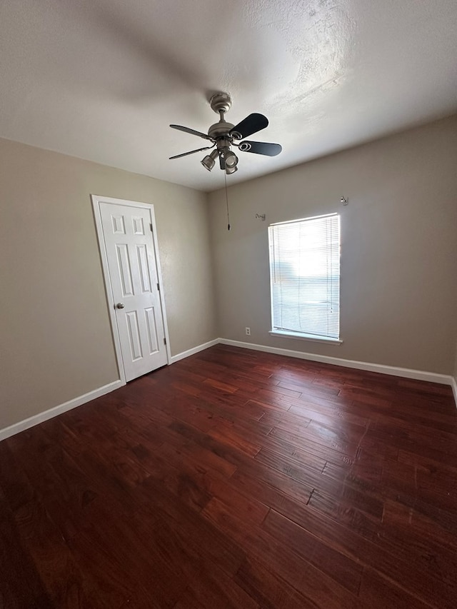 1844 E 50th St, Odessa, TX 79762 - spare room featuring a ceiling fan and dark wood-style flooring