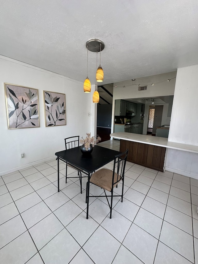 1844 E 50th St, Odessa, TX 79762 - dining room with light tile patterned flooring and a textured ceiling