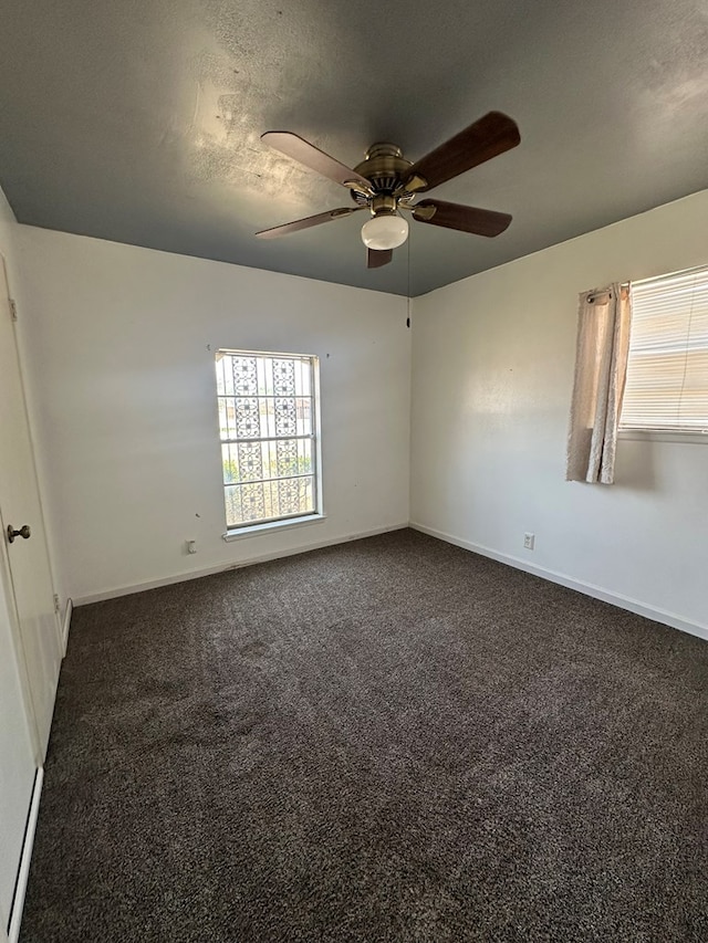 1844 E 50th St, Odessa, TX 79762 - spare room featuring dark carpet and a ceiling fan