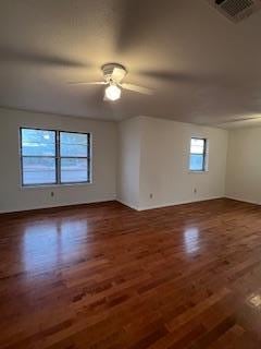 unfurnished room featuring ceiling fan and dark hardwood / wood-style flooring